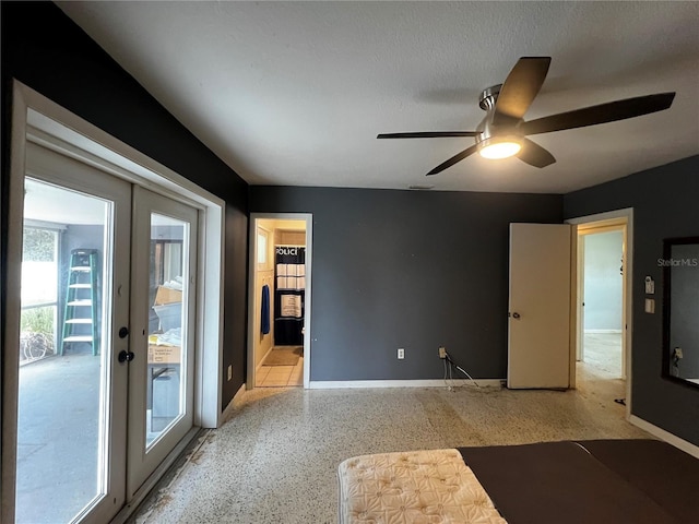 interior space featuring a textured ceiling, ceiling fan, and french doors