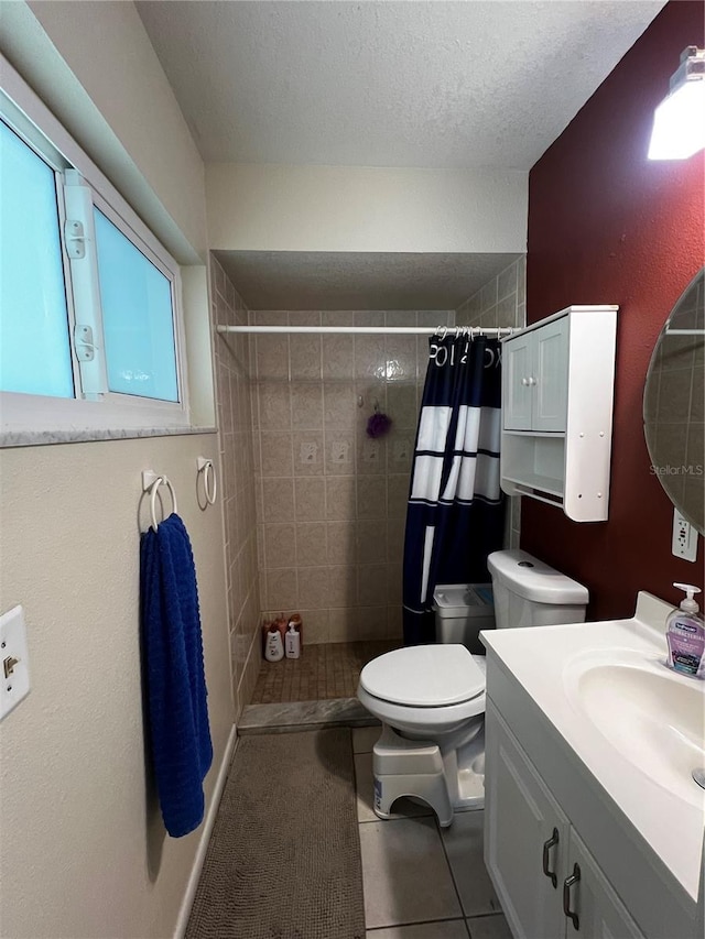 bathroom featuring tile patterned flooring, vanity, a textured ceiling, a shower with curtain, and toilet