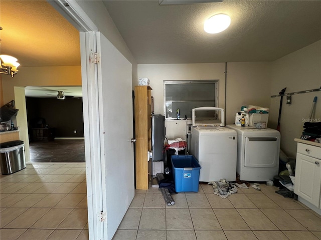 laundry area with light tile patterned floors, a textured ceiling, and independent washer and dryer