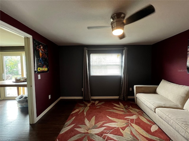 interior space featuring ceiling fan, dark hardwood / wood-style floors, and a textured ceiling