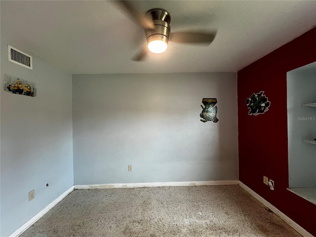 empty room featuring a textured ceiling and ceiling fan