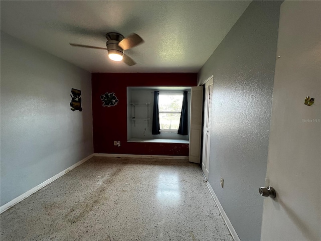 unfurnished room featuring ceiling fan and a textured ceiling