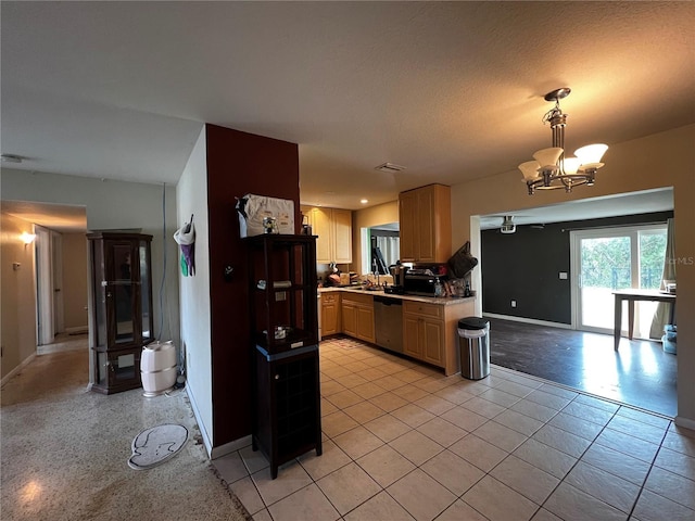 kitchen with sink, hanging light fixtures, light tile patterned floors, dishwasher, and a notable chandelier