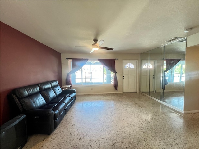 1405 Dorchester St, Port Charlotte, FL 33952 - unfurnished living room featuring baseboards, a ceiling fan, and speckled floor