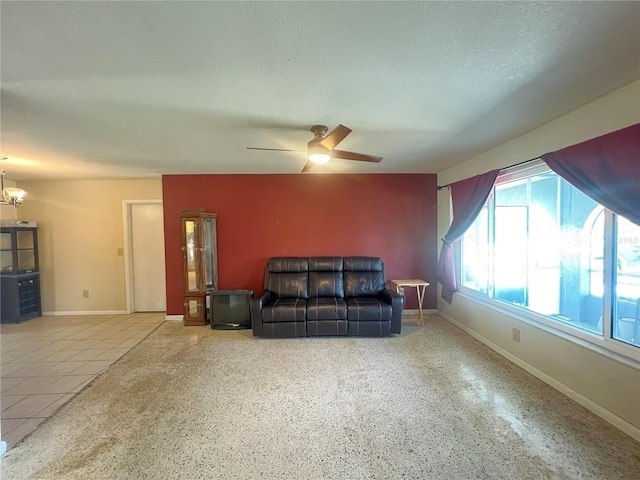 1405 Dorchester St, Port Charlotte, FL 33952 - living room with ceiling fan, baseboards, and a textured ceiling