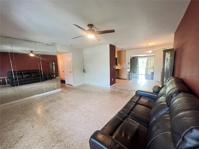 1405 Dorchester St, Port Charlotte, FL 33952 - living room featuring a ceiling fan, dark speckled floor, baseboards, and a chandelier