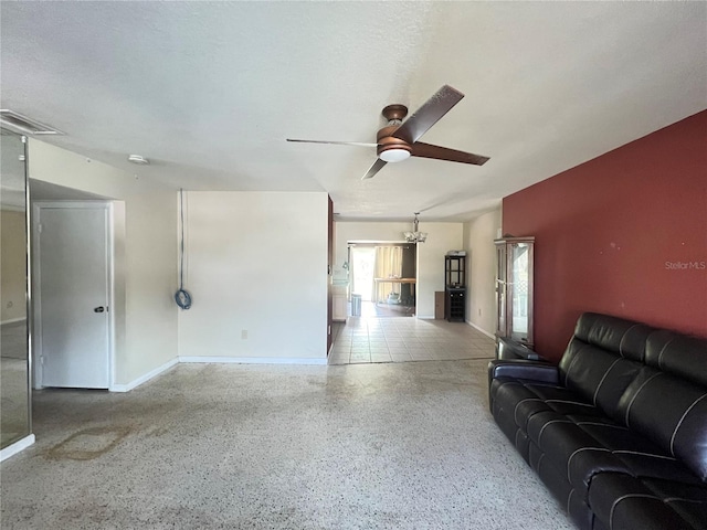 1405 Dorchester St, Port Charlotte, FL 33952 - living area featuring a ceiling fan, speckle patterned floor, and baseboards