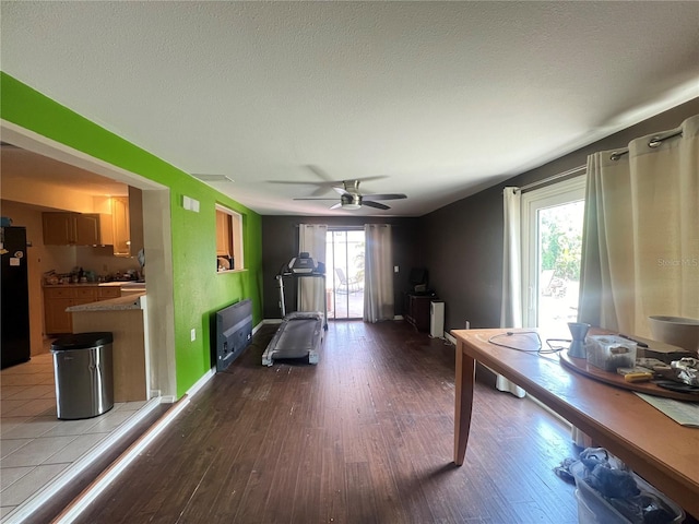 1405 Dorchester St, Port Charlotte, FL 33952 - exercise room with wood finished floors, a ceiling fan, and baseboards