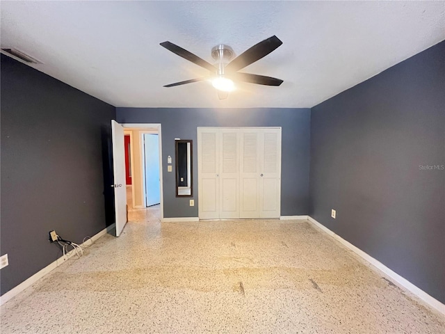 1405 Dorchester St, Port Charlotte, FL 33952 - unfurnished bedroom featuring speckled floor, baseboards, a closet, and ceiling fan