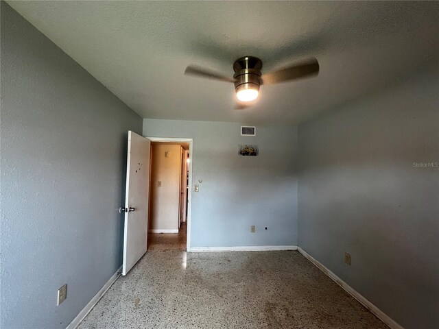 1405 Dorchester St, Port Charlotte, FL 33952 - spare room with ceiling fan, baseboards, and speckled floor