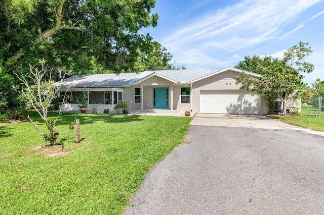 ranch-style house with a front yard, a garage, and a porch