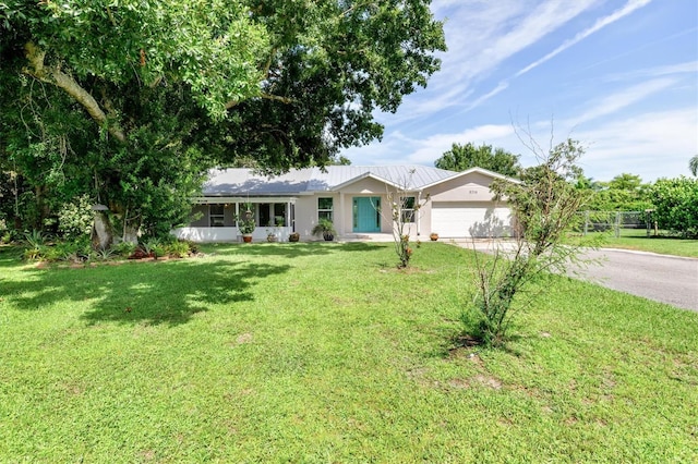 ranch-style house with a garage and a front lawn