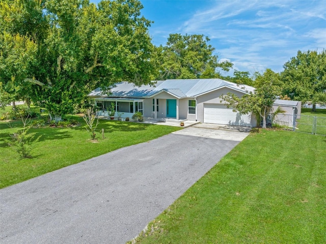 ranch-style house featuring a garage and a front lawn