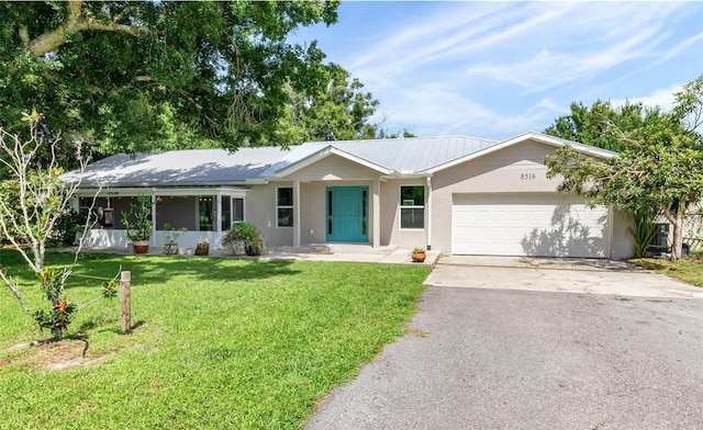 8516 Riverside Dr, Punta Gorda, FL 33982 - single story home with stucco siding, an attached garage, driveway, and a front lawn