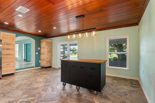 kitchen with wooden ceiling, dark cabinets, visible vents, hanging light fixtures, and a center island