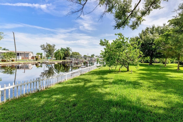 view of yard featuring a water view and fence