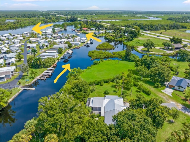 birds eye view of property with a water view and a residential view