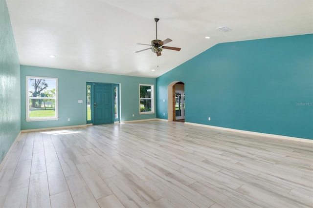 unfurnished living room with light wood-type flooring, ceiling fan, and lofted ceiling