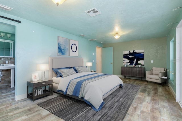 8516 Riverside Dr, Punta Gorda, FL 33982 - bedroom with wood finished floors, visible vents, and baseboards