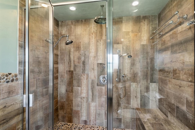 bathroom with a shower with door