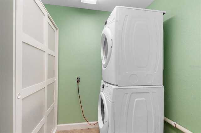 laundry room featuring laundry area and stacked washer / drying machine