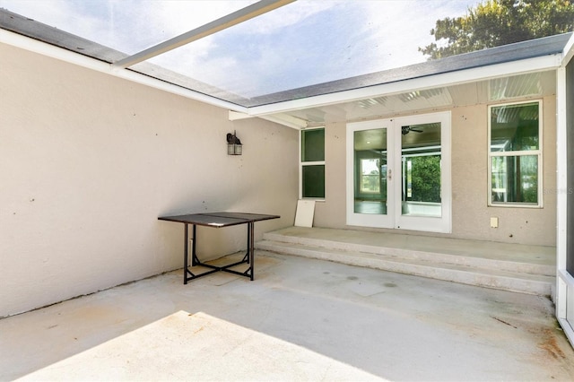 doorway to property featuring stucco siding, french doors, and a patio