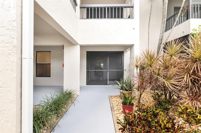 doorway to property with stucco siding