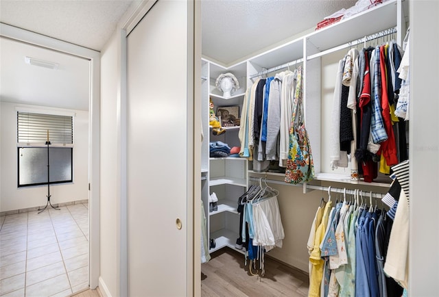 spacious closet with light tile patterned flooring