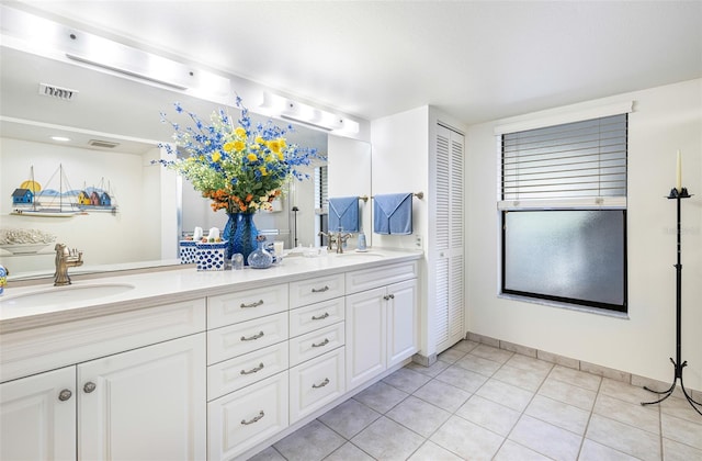 bathroom with tile patterned flooring and vanity