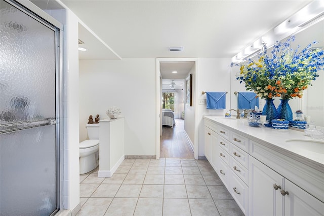 bathroom featuring vanity, toilet, wood-type flooring, and an enclosed shower