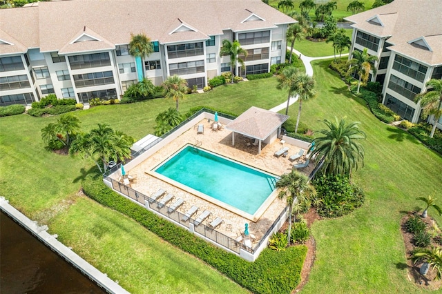 view of swimming pool featuring a lawn and a patio