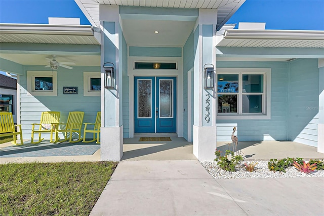 doorway to property featuring ceiling fan and a porch