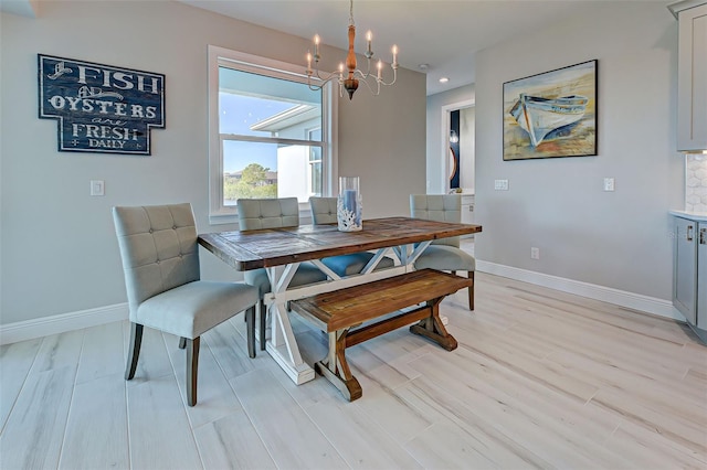 dining space featuring a notable chandelier and light hardwood / wood-style flooring