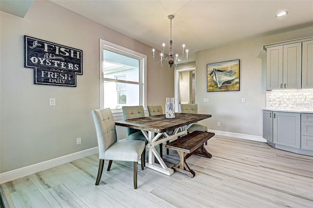 dining room featuring an inviting chandelier and light wood-type flooring