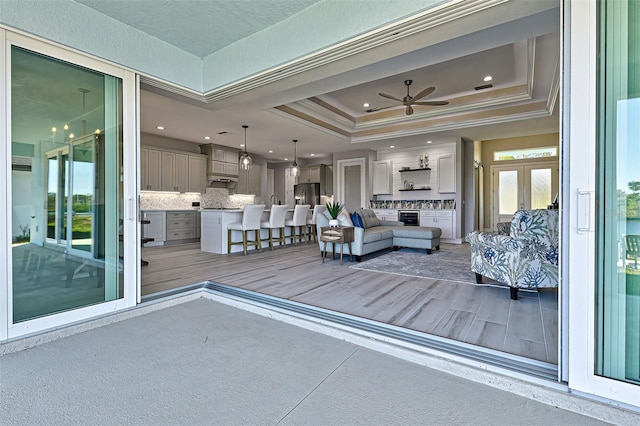 interior space with an outdoor hangout area and ceiling fan