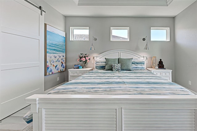 bedroom featuring a barn door and multiple windows