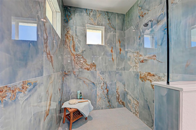 bathroom featuring a healthy amount of sunlight and a tile shower