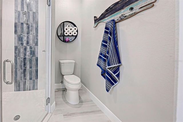 bathroom with an enclosed shower and toilet