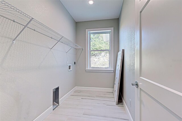 laundry area featuring washer hookup, hookup for an electric dryer, and light wood-type flooring