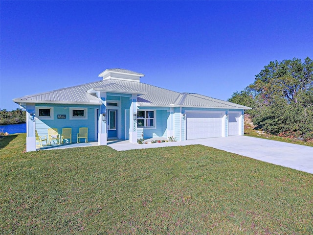 view of front of home with a garage and a front lawn