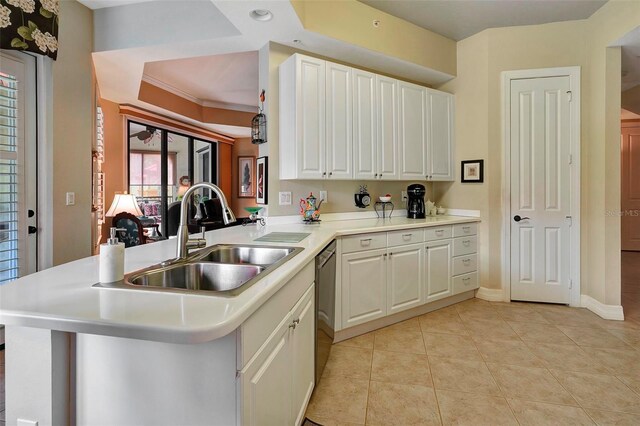 kitchen with kitchen peninsula, light tile patterned flooring, sink, and white cabinets