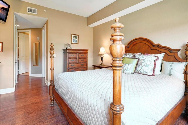 bedroom with dark hardwood / wood-style flooring