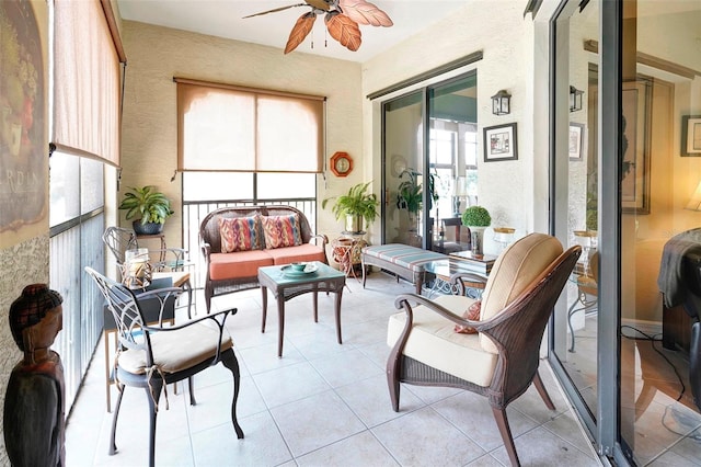 sunroom featuring ceiling fan