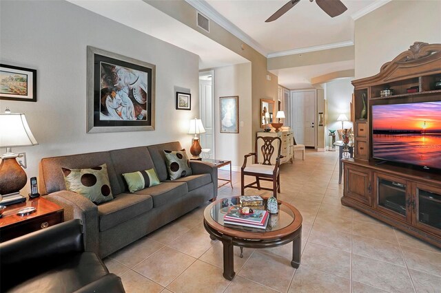 living room with ceiling fan, light tile patterned floors, and ornamental molding