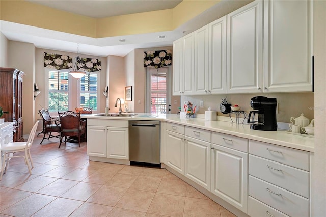 kitchen with stainless steel dishwasher, sink, hanging light fixtures, and white cabinets