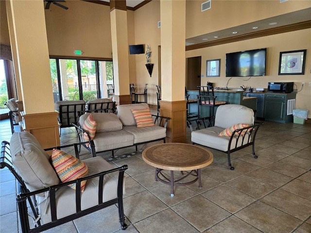 96 Vivante Blvd Unit 96211, Punta Gorda, FL 33950 - living room with a high ceiling, crown molding, and tile patterned flooring