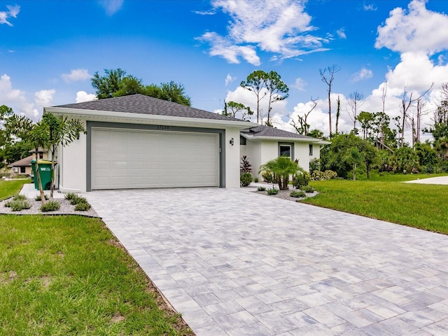 ranch-style home with a garage and a front lawn