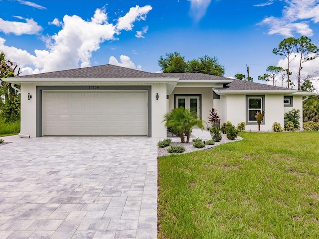 single story home with a garage and a front yard