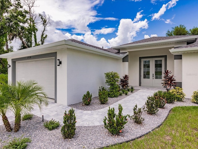 view of property exterior with french doors and a garage