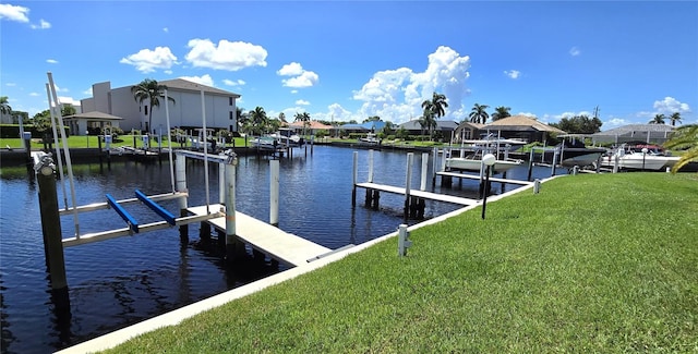 view of dock with a water view and a lawn